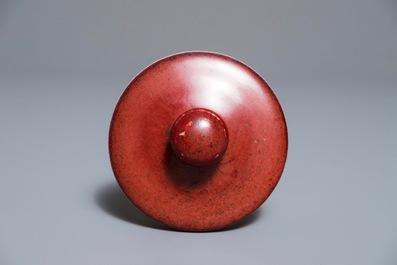 A Chinese monochrome oxblood-glazed jar and cover, 19th C.