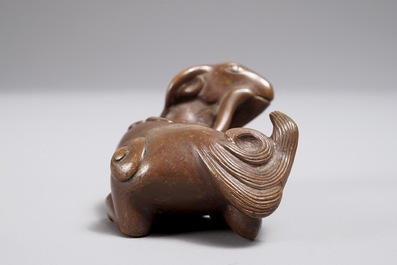 A Chinese bronze scroll or paper weight shaped as a ram, 17/18th C.