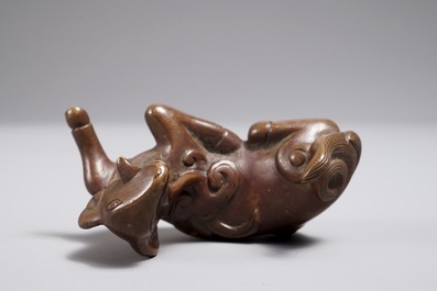 A Chinese bronze scroll or paper weight shaped as a ram, 17/18th C.