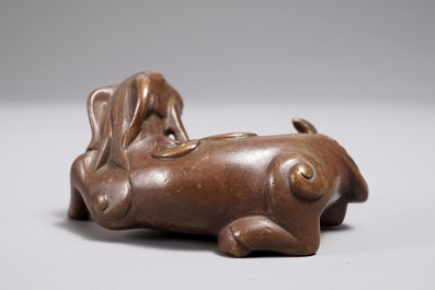 A Chinese bronze scroll or paper weight shaped as a ram, 17/18th C.