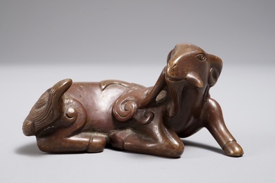 A Chinese bronze scroll or paper weight shaped as a ram, 17/18th C.