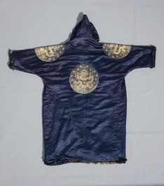A blue-ground silk coat composed of Imperial Chinese gold thread dragon badges, 19th C.