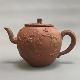 Two Chinese Yixing stoneware teapots with applied floral design, Kangxi