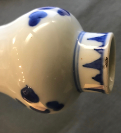 A Chinese blue and white bottle vase with floral design, Transitional period