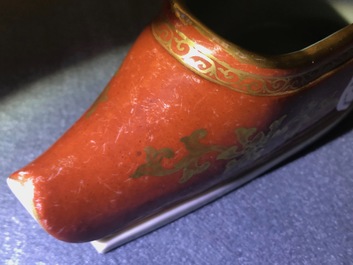 A Chinese coral-ground and gilt miniature shoe with hidden famille rose erotical design, 19/20th C.