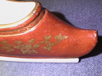 A Chinese coral-ground and gilt miniature shoe with hidden famille rose erotical design, 19/20th C.
