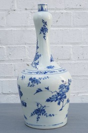 A Chinese blue and white bottle vase with floral design, Transitional period