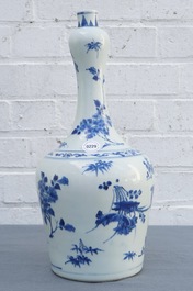 A Chinese blue and white bottle vase with floral design, Transitional period
