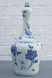 A Chinese blue and white bottle vase with floral design, Transitional period
