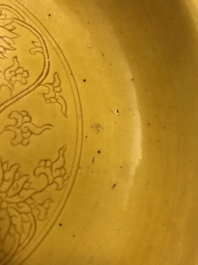 A Chinese monochrome yellow dish with incised lotus design, Kangxi mark, 20th C.