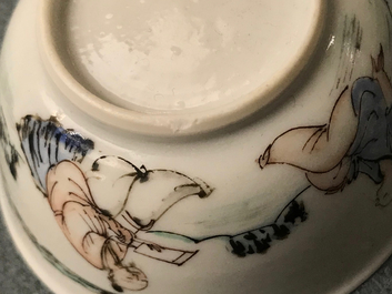 A Chinese cup and saucer with two figures in a landscape, Yongzheng