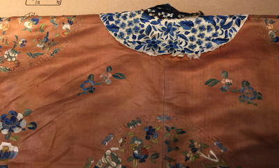 A Chinese orange-ground embroidered silk robe, 19th C.