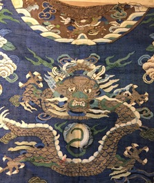 A Chinese blue-ground kesi eight-dragon robe, 19th C.