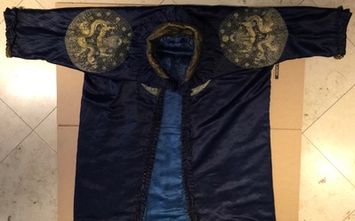 A blue-ground silk coat composed of Imperial Chinese gold thread dragon badges, 19th C.