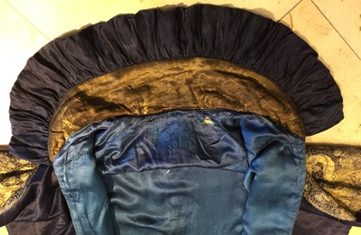 A blue-ground silk coat composed of Imperial Chinese gold thread dragon badges, 19th C.