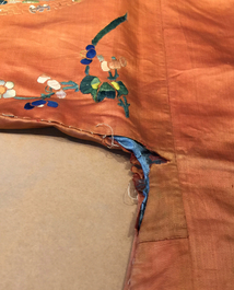 A Chinese orange-ground embroidered silk robe, 19th C.