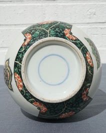 A Chinese famille verte bottle vase with fine flower baskets, 19th C.