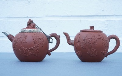Two Chinese Yixing stoneware teapots with applied floral design, Kangxi