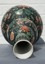 A Chinese black-ground famille verte double gourd dragon vase, 19th C.