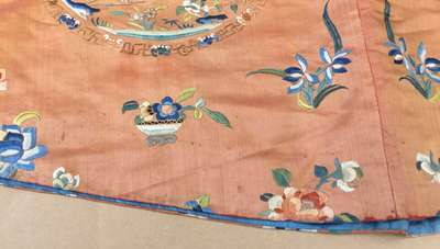 A Chinese orange-ground embroidered silk robe, 19th C.