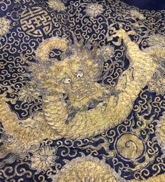 A blue-ground silk coat composed of Imperial Chinese gold thread dragon badges, 19th C.