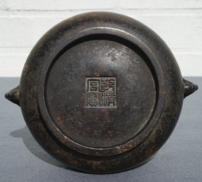 A Chinese bronze incense burner with elephant head handles, qianqing gongbao mark, Ming