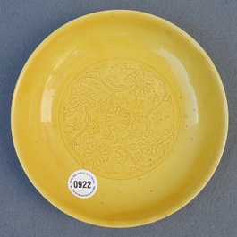 A Chinese monochrome yellow dish with incised lotus design, Kangxi mark, 20th C.