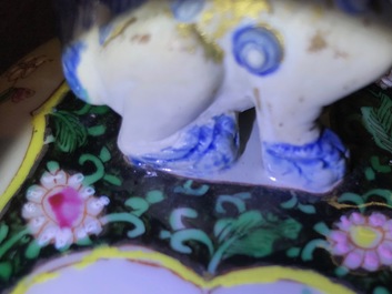 A pair of Chinese famille rose black-ground vases and covers, Yongzheng