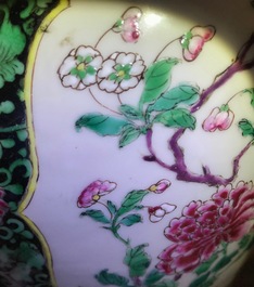 A pair of Chinese famille rose black-ground vases and covers, Yongzheng