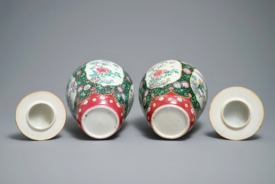 A pair of Chinese famille rose black-ground vases and covers, Yongzheng