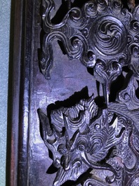 A Chinese carved wood frame depicting mythical beasts, 19th C.