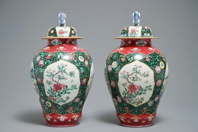 A pair of Chinese famille rose black-ground vases and covers, Yongzheng