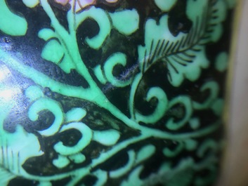 A pair of Chinese famille rose black-ground vases and covers, Yongzheng