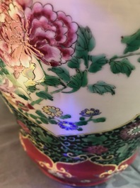 A pair of Chinese famille rose black-ground vases and covers, Yongzheng