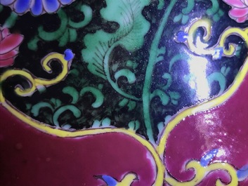 A pair of Chinese famille rose black-ground vases and covers, Yongzheng