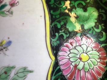 A pair of Chinese famille rose black-ground vases and covers, Yongzheng