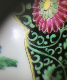 A pair of Chinese famille rose black-ground vases and covers, Yongzheng
