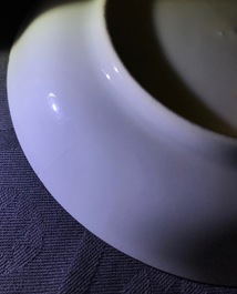 A Chinese famille verte teapot and milk jug, 19th C., and a famille rose cup and saucer, Qianlong