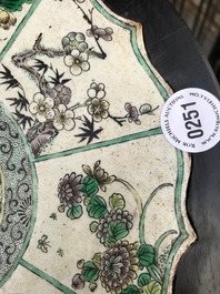 A Chinese verte biscuit lotus-shaped dragon plaque mounted in a wooden stand, Kangxi