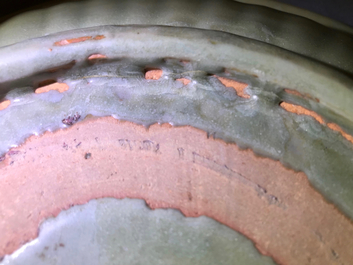 A Chinese Longquan celadon charger with underglaze dragon, Ming