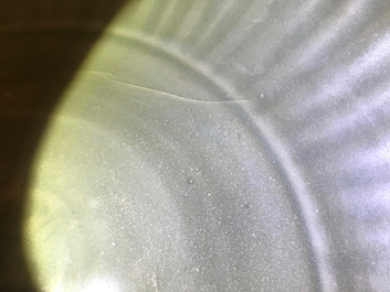 A Chinese Longquan celadon charger with underglaze dragon, Ming