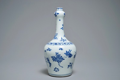 A Chinese blue and white bottle vase with floral design, Transitional period