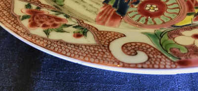 A Chinese famille rose plate with figures around a carriage, Yongzheng