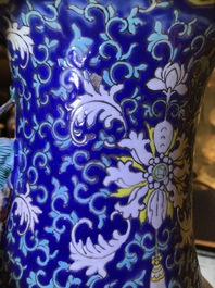 A pair of Chinese famille rose blue-ground vases, 19th C.