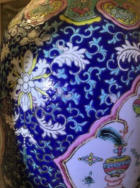 A pair of Chinese famille rose blue-ground vases, 19th C.