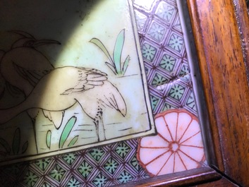 Two Chinese famille verte plaques in openworked wooden frames, 19/20th C.