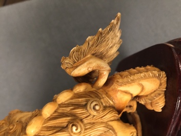 A Chinese carved ivory group of Buddhist lions playing with a ball, 19/20th C.