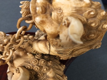 A Chinese carved ivory group of Buddhist lions playing with a ball, 19/20th C.