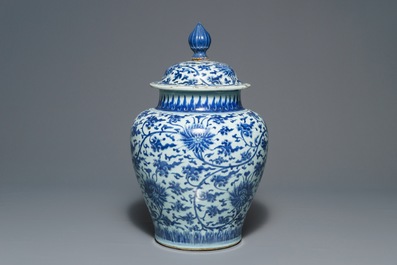 A tall Chinese blue and white 'lotus scroll' vase and cover, Kangxi