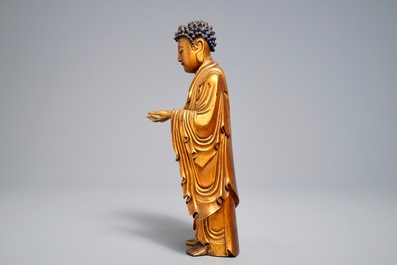 A Chinese carved gilt wood figure of Buddha standing, 18/19th C.